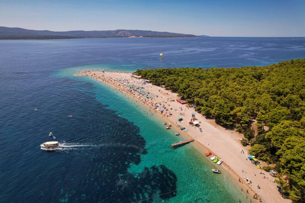 The beach in croatia with boats and people